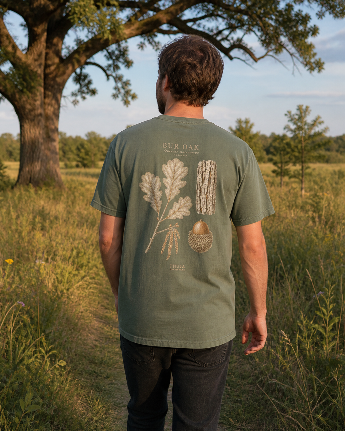Man wearing the Moss Bur Oak Botanical T-Shirt on a bur oak savanna trail, back view