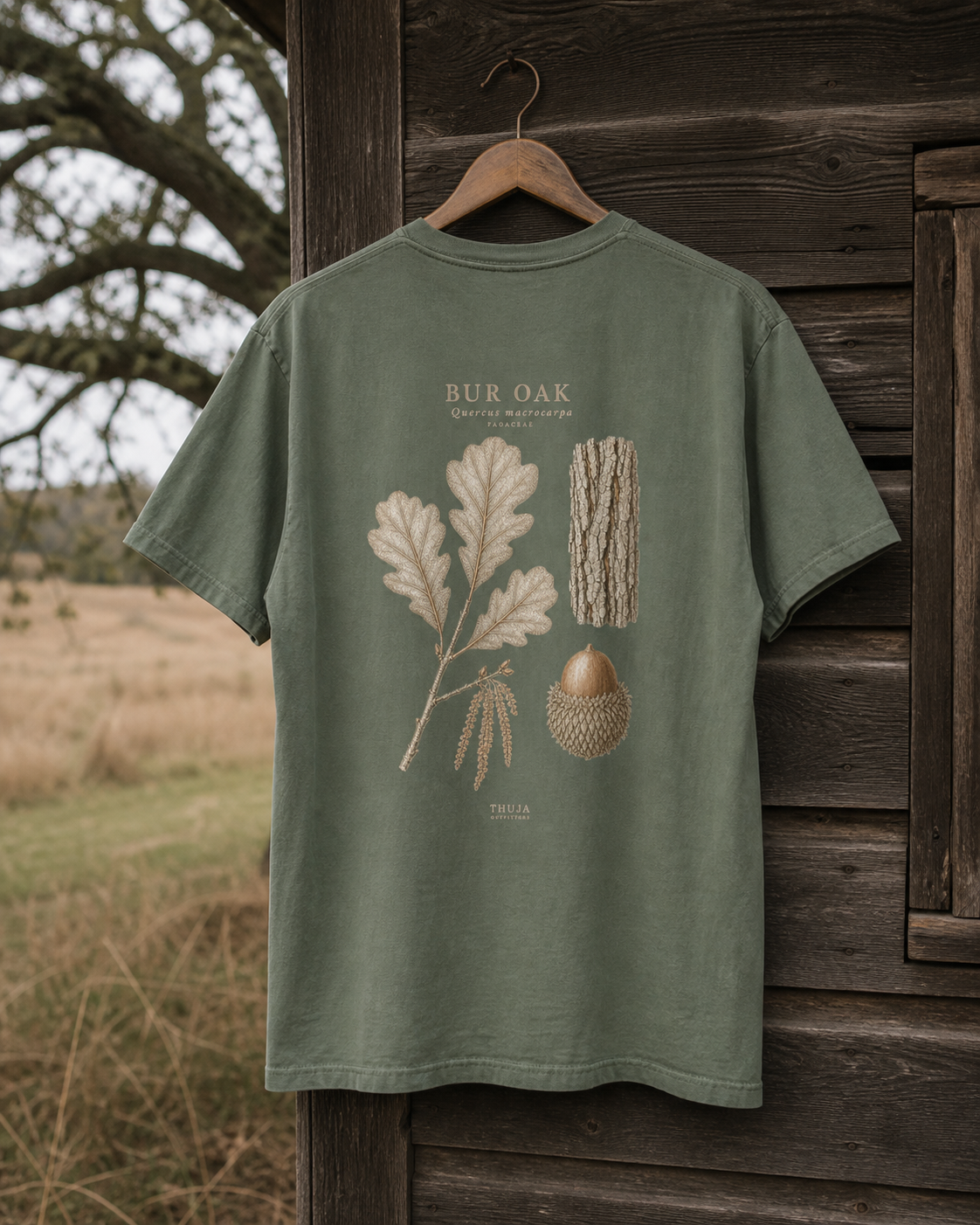 Moss Comfort Colors 1717 Bur Oak Botanical T-Shirt hanging outside a cabin in bur oak savanna