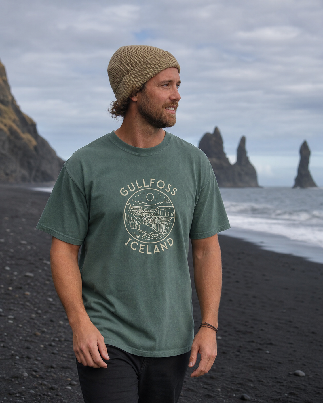 Person wearing the Blue Spruce Gullfoss Iceland T-Shirt on Icelandic black sand