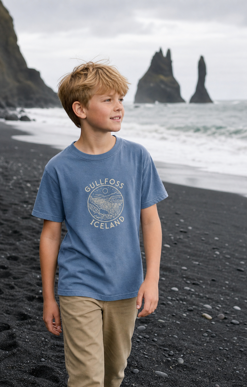 Child wearing the Blue Jean Kids Gullfoss Iceland T-Shirt on Icelandic black sand