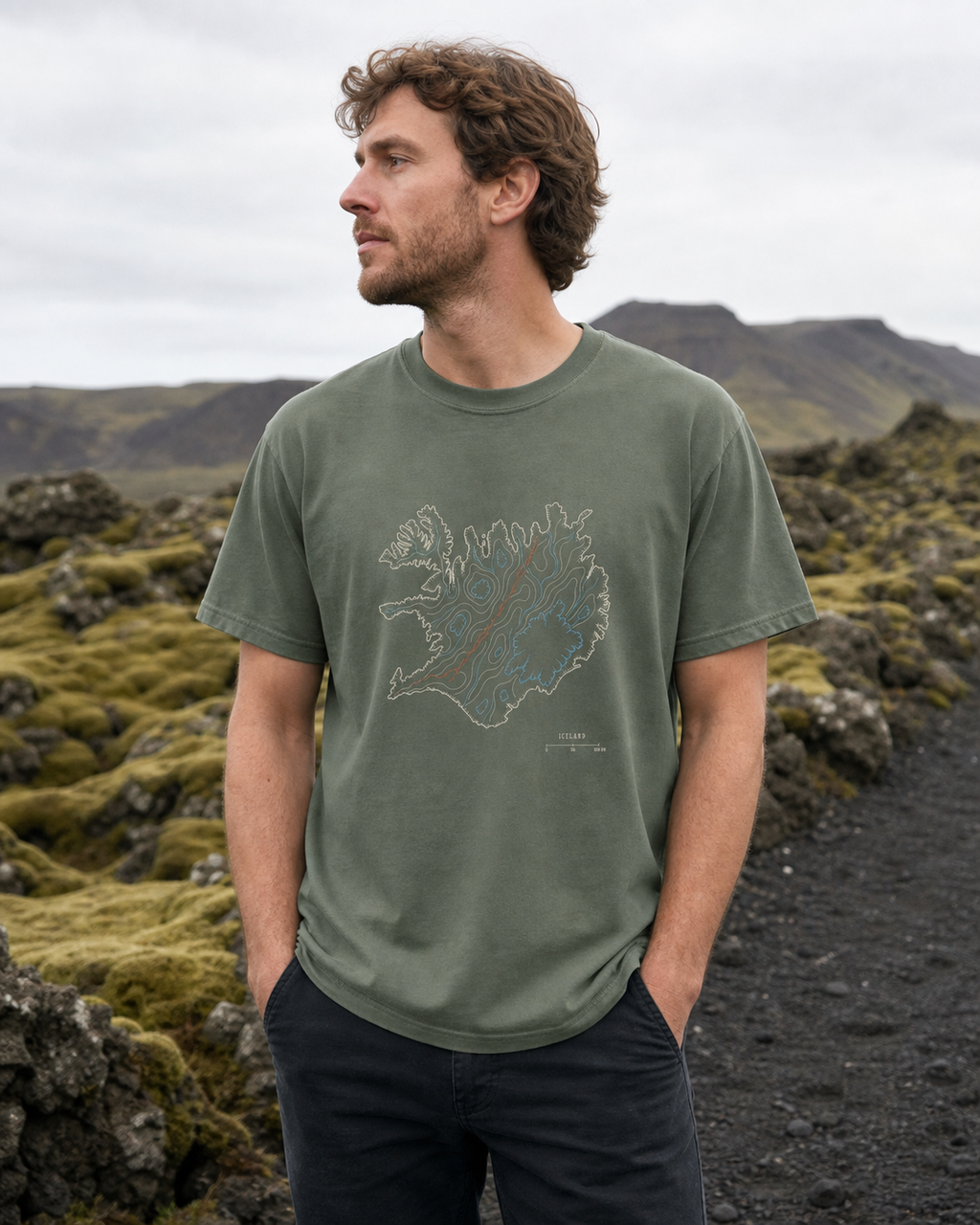 Man wearing the Moss Iceland Rifted Relief T-Shirt on an Icelandic moss-covered lava trail
