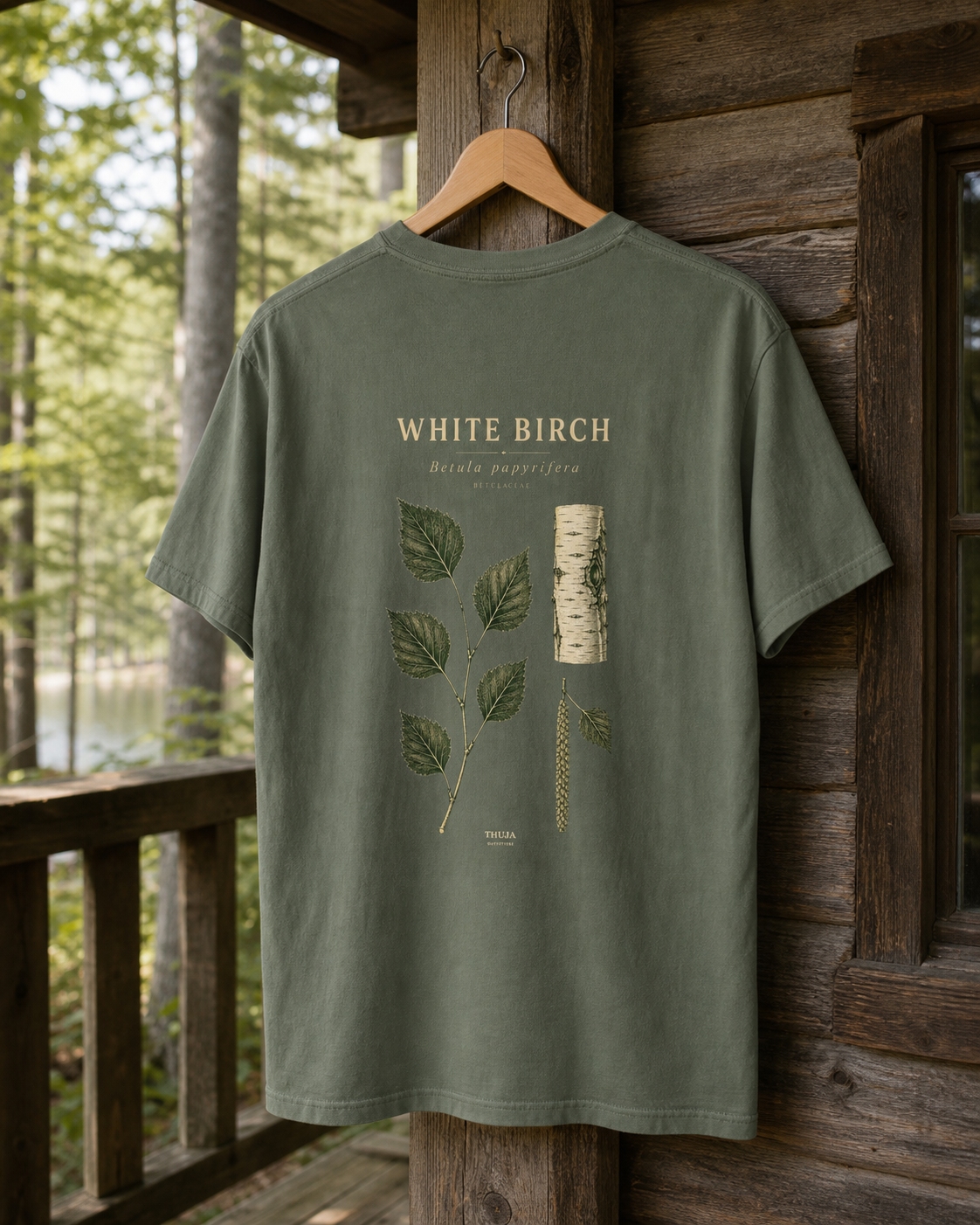 Moss White Birch Botanical T-Shirt with the updated botanical back print on a cabin porch hanger